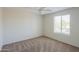 Clean bedroom with window and carpet at 43594 W Bravo Ct, Maricopa, AZ 85138