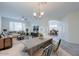 Open concept dining area with a large table and access to the living room at 43594 W Bravo Ct, Maricopa, AZ 85138