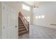 Inviting foyer with a staircase, high ceilings, and ample natural light from the windows at 43594 W Bravo Ct, Maricopa, AZ 85138