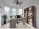 Bright home office features built-in shelving and large windows at 43594 W Bravo Ct, Maricopa, AZ 85138