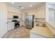 Stylish kitchen with stainless steel appliances, neutral cabinets, and durable countertops at 43594 W Bravo Ct, Maricopa, AZ 85138