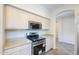 Modern kitchen showcasing stainless steel range, microwave, and neutral countertop at 43594 W Bravo Ct, Maricopa, AZ 85138