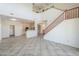 Open-concept space with tiled floors and staircase view looking towards kitchen and living areas at 43594 W Bravo Ct, Maricopa, AZ 85138