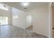 Bright, open-plan living room with tile floors and slider doors to the back yard at 43594 W Bravo Ct, Maricopa, AZ 85138