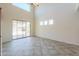 Bright living room featuring tile floors, multiple windows, and sliding glass doors to the backyard at 43594 W Bravo Ct, Maricopa, AZ 85138