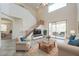 Spacious living room with high ceilings and access to backyard patio at 43594 W Bravo Ct, Maricopa, AZ 85138