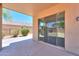 A view from the covered patio shows the backyard and the exterior of the home at 43594 W Bravo Ct, Maricopa, AZ 85138