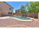 Backyard pool with beautiful desert landscaping and a privacy fence, perfect for relaxation at 43594 W Bravo Ct, Maricopa, AZ 85138