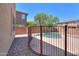 Backyard view of a fenced pool area with desert landscaping, offering privacy and outdoor enjoyment at 43594 W Bravo Ct, Maricopa, AZ 85138