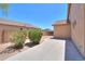 The side yard features a landscaped walkway with desert plants and a view of the home's exterior at 43594 W Bravo Ct, Maricopa, AZ 85138