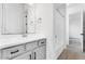 Bright bathroom showcasing a white vanity with gray cabinets, wood look tile flooring and shower/tub combo at 5845 S Romano --, Mesa, AZ 85212