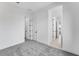 Bright bedroom featuring neutral paint, carpets, and multiple doors enhancing flow and space at 5845 S Romano --, Mesa, AZ 85212