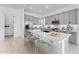 Bright kitchen featuring gray cabinets, stainless steel appliances, and a large white countertop island with seating at 5845 S Romano --, Mesa, AZ 85212