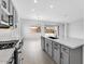 Bright, modern kitchen with stainless steel appliances, large island, and sleek gray cabinetry at 5845 S Romano --, Mesa, AZ 85212