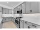 Stylish kitchen featuring gray cabinets, quartz countertops, and stainless steel gas range at 5845 S Romano --, Mesa, AZ 85212