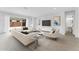 Bright living room with white walls, neutral furniture, modern art, and sliding glass doors to the outdoor space at 5845 S Romano --, Mesa, AZ 85212