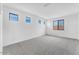 Light-filled bedroom with plush carpeting and multiple windows offering neighborhood views at 5851 S Romano --, Mesa, AZ 85212