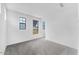 Spacious bedroom with soft carpet, offering natural light and neighborhood views through multiple windows at 5851 S Romano --, Mesa, AZ 85212