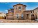 Charming two-story home featuring stucco and stone accents and a paved driveway at 5851 S Romano --, Mesa, AZ 85212
