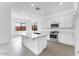 Modern kitchen boasts white cabinets, stainless steel appliances, and center island at 5851 S Romano --, Mesa, AZ 85212