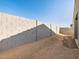 Spacious backyard featuring a block wall for added privacy and a dirt ground ready for landscaping at 16034 W Desert Hollow Dr, Surprise, AZ 85387