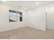 Bright bedroom with neutral tile floors and a large window providing natural light at 16034 W Desert Hollow Dr, Surprise, AZ 85387