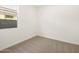 Bedroom with neutral carpet and a bright window at 16034 W Desert Hollow Dr, Surprise, AZ 85387