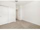 Bright bedroom featuring neutral carpet and a spacious closet at 16034 W Desert Hollow Dr, Surprise, AZ 85387