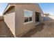 Exterior view featuring neutral colors, windows, and a sliding door at 16034 W Desert Hollow Dr, Surprise, AZ 85387