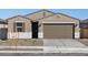 Beautiful single-story home features neutral tones, desert landscaping, and a two-car garage at 16034 W Desert Hollow Dr, Surprise, AZ 85387