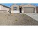 Inviting single-story home with a two car garage and desert landscaping at 16034 W Desert Hollow Dr, Surprise, AZ 85387
