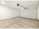 A two car garage with concrete floor and a modern garage door opener at 16034 W Desert Hollow Dr, Surprise, AZ 85387