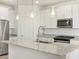 Modern kitchen featuring stainless steel appliances, granite countertops, and pendant lighting at 16034 W Desert Hollow Dr, Surprise, AZ 85387