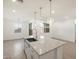 Kitchen island featuring granite countertops, stainless steel sink and ample natural light at 16034 W Desert Hollow Dr, Surprise, AZ 85387