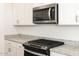 Updated kitchen featuring stainless steel appliances and granite countertops at 16034 W Desert Hollow Dr, Surprise, AZ 85387