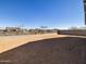 Backyard with neutral dirt at 16062 W Prickly Pear Trl, Surprise, AZ 85387