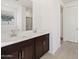 This bathroom has double sinks, a large mirror, dark wood cabinetry, and a shower at 16062 W Prickly Pear Trl, Surprise, AZ 85387