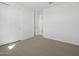 Neutral bedroom with carpet, a window, and white closet doors at 16062 W Prickly Pear Trl, Surprise, AZ 85387