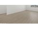 Bright bedroom featuring light wood floors, white walls, and a window at 16062 W Prickly Pear Trl, Surprise, AZ 85387