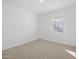 Bright bedroom with neutral carpet and a window at 16062 W Prickly Pear Trl, Surprise, AZ 85387