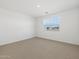 Bright bedroom features neutral carpeting, large windows and ample natural light at 16062 W Prickly Pear Trl, Surprise, AZ 85387