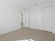 Neutral bedroom with carpet, a window, and closet doors at 16062 W Prickly Pear Trl, Surprise, AZ 85387