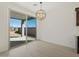 Dining room with backyard view, wood tile floor, modern light fixture at 16062 W Prickly Pear Trl, Surprise, AZ 85387