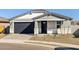 Charming single-story home with a gray exterior, stone accents, and a well-manicured front yard at 16062 W Prickly Pear Trl, Surprise, AZ 85387