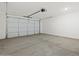 Spacious garage with concrete floors and white garage door at 16062 W Prickly Pear Trl, Surprise, AZ 85387