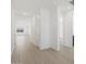 Bright hallway with tile floors leading to various rooms, showing an open floor plan at 16062 W Prickly Pear Trl, Surprise, AZ 85387