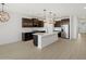 Open kitchen layout with an island, stainless steel appliances, and elegant pendant lighting at 16062 W Prickly Pear Trl, Surprise, AZ 85387