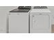 Modern laundry room featuring a white Whirlpool washer and dryer set at 16062 W Prickly Pear Trl, Surprise, AZ 85387