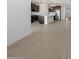 Open-concept space showcasing hardwood floors and access to the kitchen at 16062 W Prickly Pear Trl, Surprise, AZ 85387