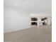 Bright, open-concept living space showcasing hardwood floors and access to the kitchen at 16062 W Prickly Pear Trl, Surprise, AZ 85387